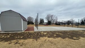 The completed, smooth concrete pad, ready for the batting cage netting and ideal for year-round training.