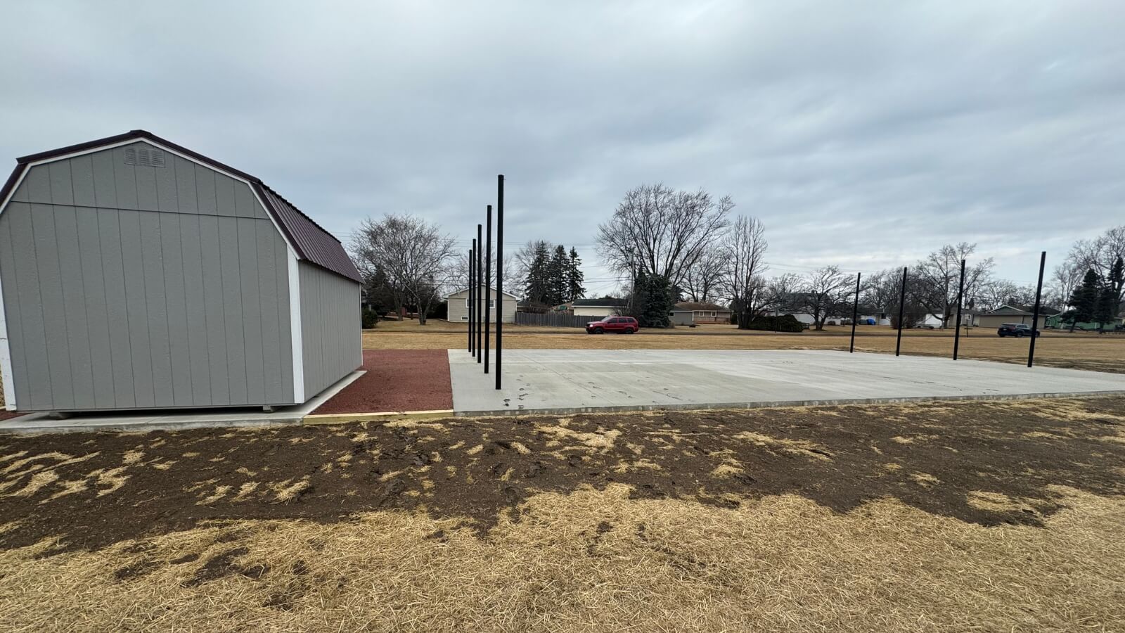 The completed, smooth concrete pad, ready for the batting cage netting and ideal for year-round training.
