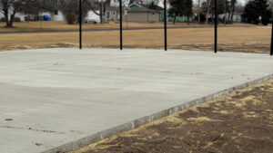 The completed, smooth concrete pad, ready for the batting cage netting and ideal for year-round training.