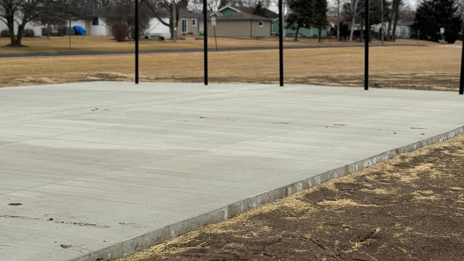The completed, smooth concrete pad, ready for the batting cage netting and ideal for year-round training.