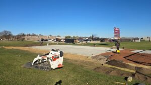 Site preparation and initial concrete work underway, ensuring a solid base for the athletic facility.