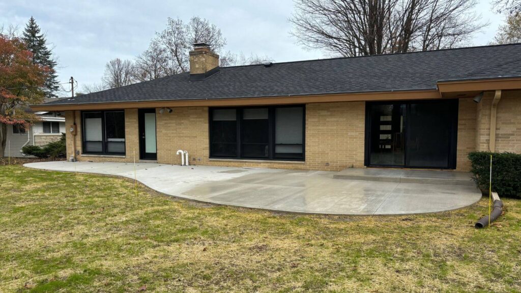 The expansive new concrete patio and stoop in Glendale, providing a spacious and inviting outdoor living area.
