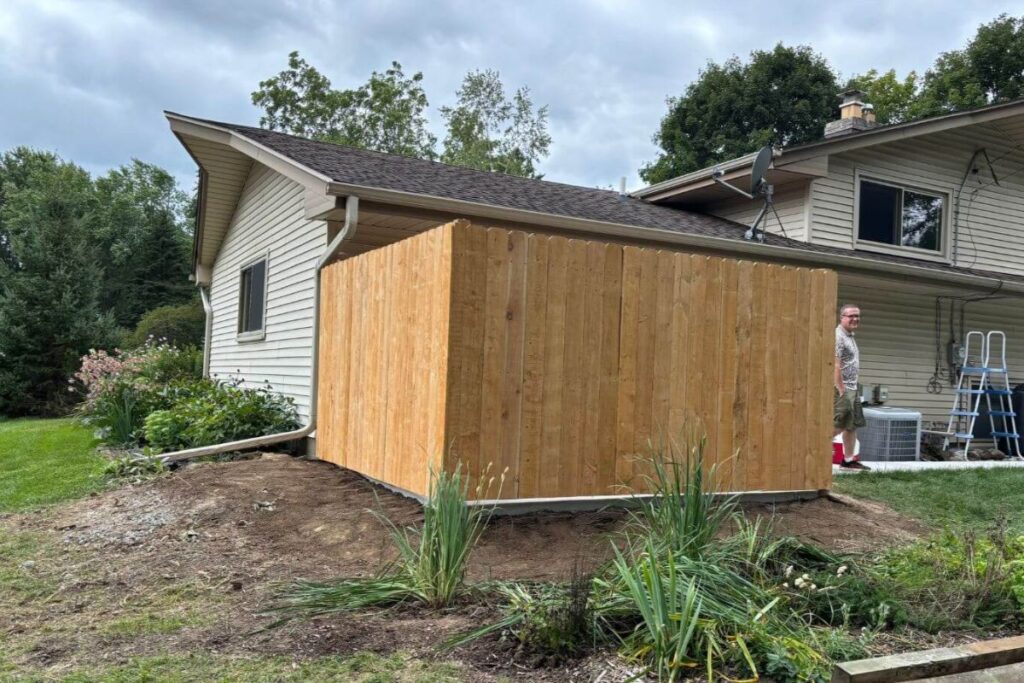 The newly installed custom wooden fence in New Berlin, enhancing privacy and seamlessly blending with the landscape.