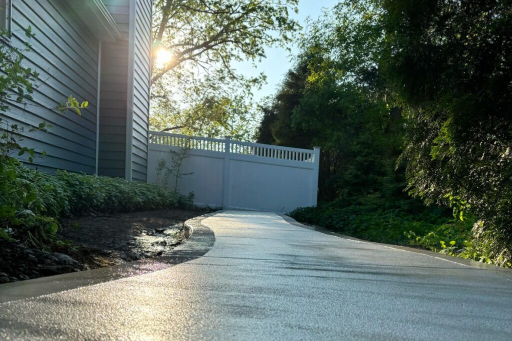 A low-angle shot of the new concrete walkway, highlighting the smooth surface and picture frame border.