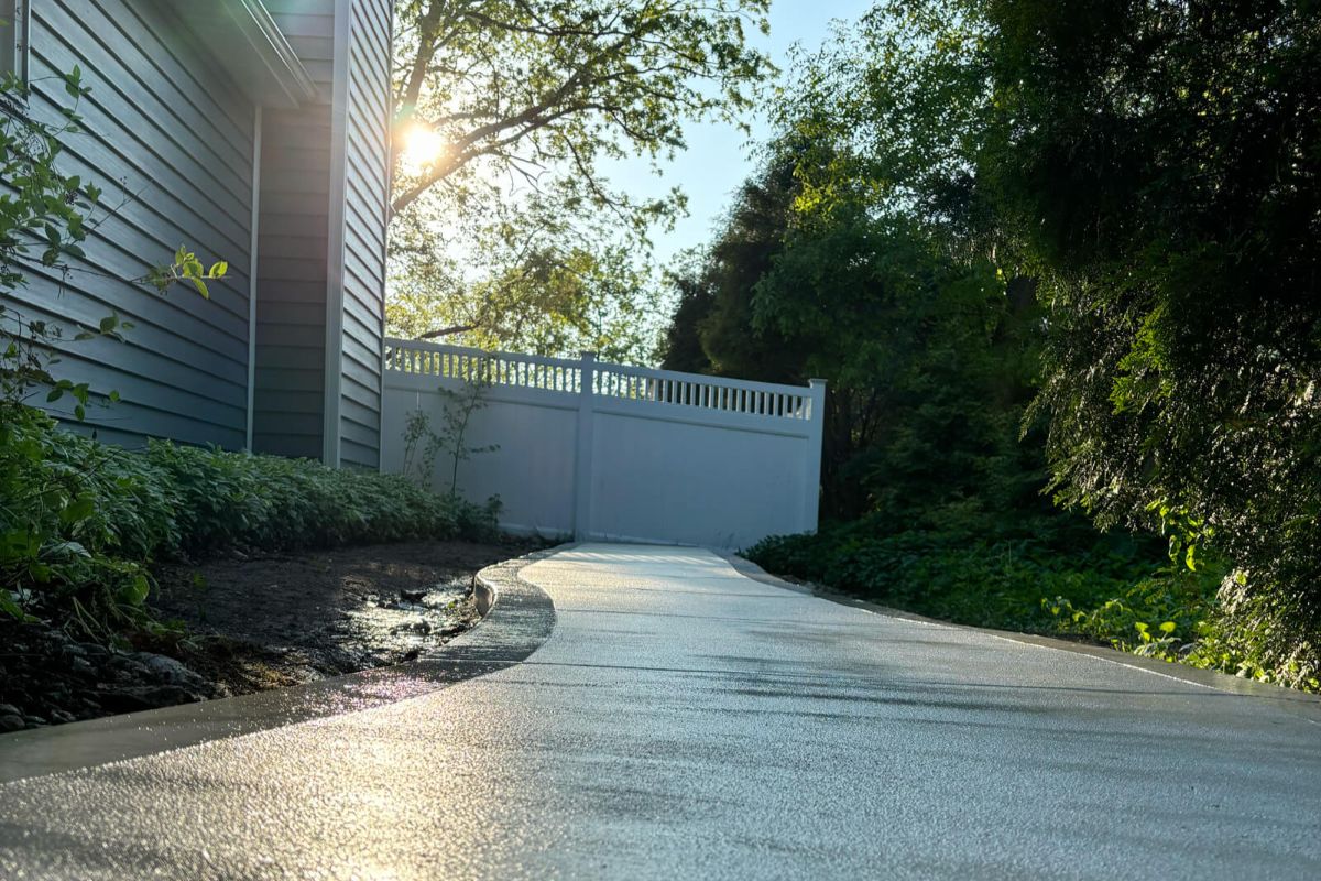 A low-angle shot of the new concrete walkway, highlighting the smooth surface and picture frame border.