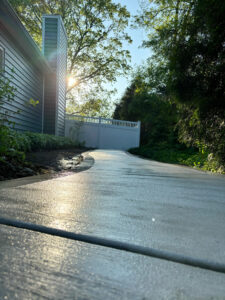 A low-angle shot of the new concrete walkway, highlighting the smooth surface and picture frame border.