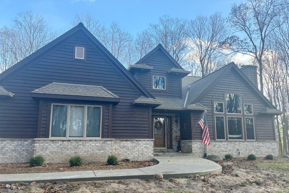 A newly installed concrete walkway with a decorative picture frame border leading up to the front entrance of a home in Slinger, WI.