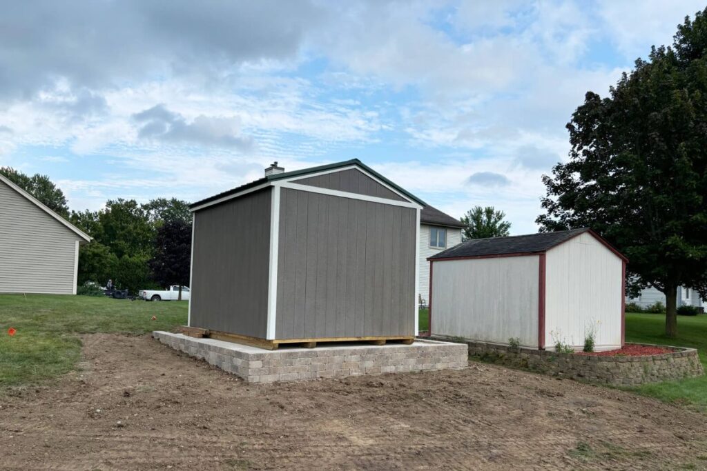 A side view of the new shed, concrete slab, and retaining wall, showing how the new structure complements the landscape.