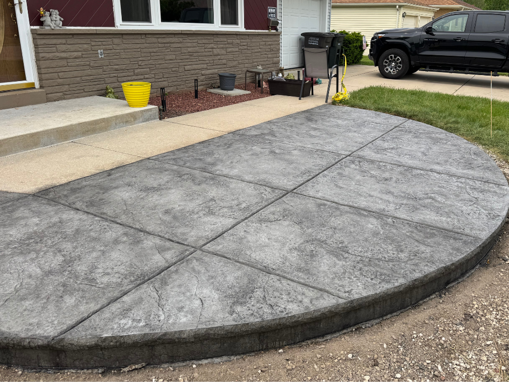 user-inserted Concrete patio featuring a set of concrete steps leading down from the surface.